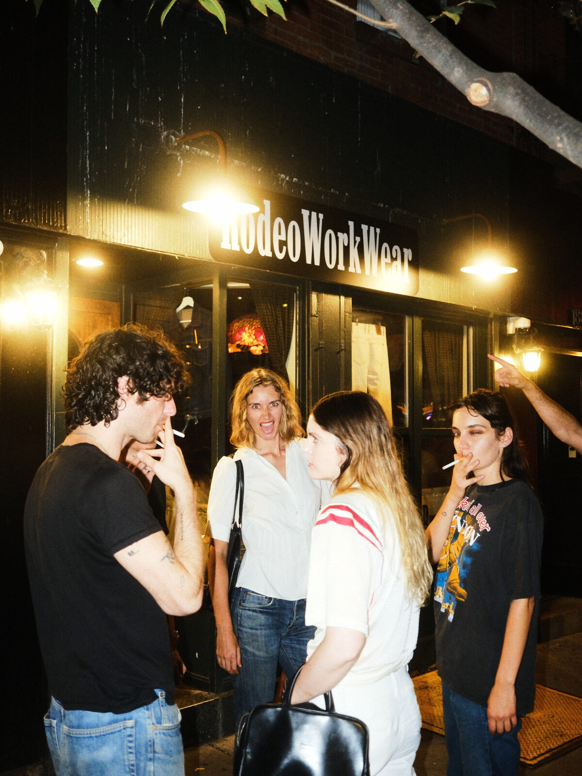 Guests gathered outside the RodeoWorkWear storefront at night